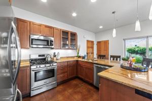 a kitchen with stainless steel appliances and wooden cabinets at 57 Robber's Roost in Moab