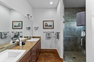 a bathroom with two sinks and a shower at 57 Robber's Roost in Moab