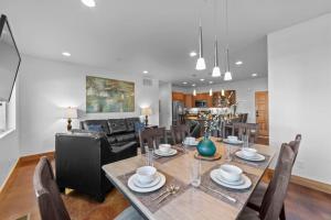 a dining room and living room with a table and chairs at 57 Robber's Roost in Moab +16 photos