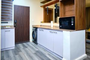 a kitchen with a washer and dryer at Revkon Apartments in Abuja +4 photos