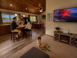 a family sitting in a living room with a baby in the floor at Family Friendly Oasis- Firepit-Puzzles-Breakfast in Mountain View