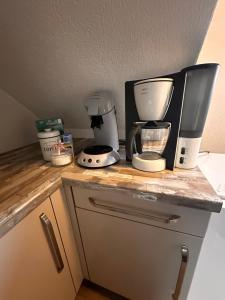 a kitchen counter with a coffee maker and a microwave at Ferienwohnung mit Schminktisch 2OG in Gräfenhainichen