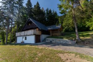 a cabin in the woods with a tree at Raj pod vrhom in Poljane nad Škofjo Loko