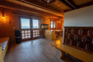 a large room with a kitchen and a dining room at Raj pod vrhom in Poljane nad Škofjo Loko