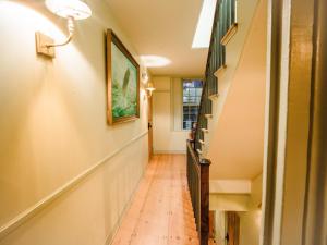 a hallway with a wooden floor and a picture on the wall at Sawyer House in Nantucket