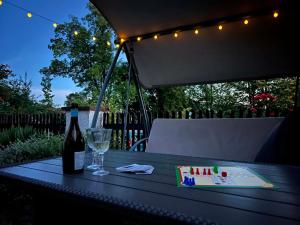 a table with a bottle of wine and a glass at Chaloupka Rozmarýna in Srbce +32 photos