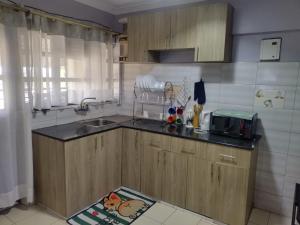 a kitchen with a sink and a counter top at Gee homestay Kakamega in Kakamega