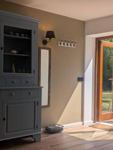a room with a dresser and a mirror and a window at Serenity Briolance in Blanquefort-sur-Briolance