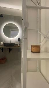a bathroom with a sink and a mirror at Dream Wellness Suite in Barletta +5 photos