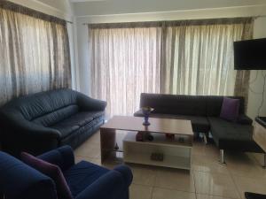 a living room with a couch and a coffee table at Maisonette Kalypso in Diakopto