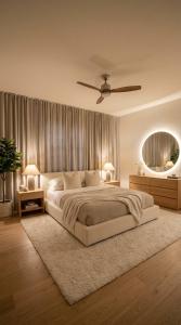 a bedroom with a large bed and a ceiling fan at ErviApartments in Tirana