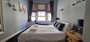 a bedroom with a bed in a room with a window at Bishop Street Apartment in Rothesay +5 photos