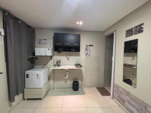 a small kitchen with a sink and a microwave at Flat 1778 N2 Orla Petrolina in Petrolina +12 photos