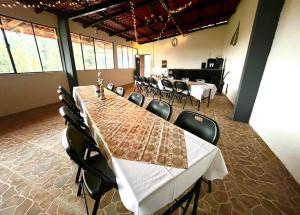 a large room with a long table and chairs at La Enamorada Cabañas & Resort in Zacatlán