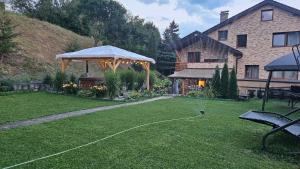 a yard with a gazebo and a house at Crown Apartment Lesná in Stará Lesná