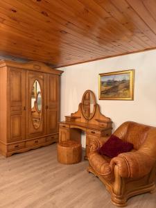 a living room with a couch and a table at Kalna Raskumu Apartamenti in Vecpiebalga