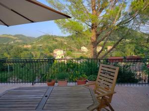 a wooden deck with a chair on a balcony at Casa del Sole 2 artenatura in Pergola