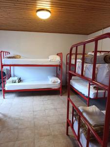 a room with three bunk beds in a room at Albergue de Ruesta in Ruesta