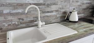 a kitchen sink with a faucet on a counter at Marso in Krašići +81 photos