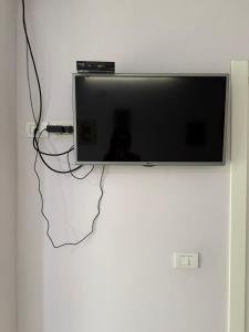 a flat screen tv hanging on a wall at Prestige ESP ROOMS in Poliçan +32 photos