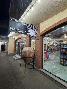a store front with a large vase in front of it at Margaliti in Telavi