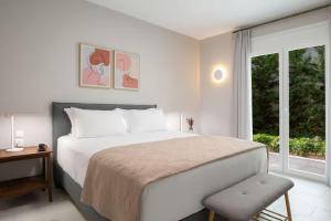 a bedroom with a large bed and a window at Dante Home's in Corfu