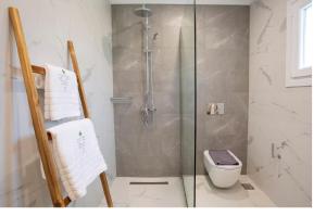 a bathroom with a shower and a toilet in it at Dante Home's in Corfu