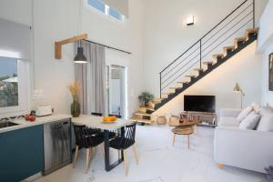 a kitchen and living room with a staircase at Dante Home's in Corfu