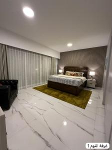 a bedroom with a bed and a large marble floor at marjan beach in Dhahran