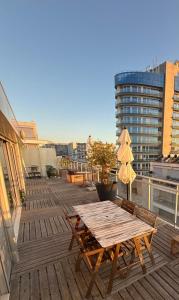 a wooden table and chairs on the roof of a building at OASIS in Buarcos