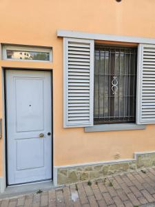 a white door and window on a building at La sosta di Strada in Strada