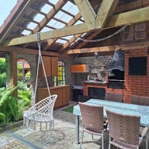 an outdoor kitchen with a table and chairs at Silnowo Kwietny Raj in Silnowo