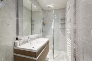 a white bathroom with a sink and a shower at Les studios de la faisanderie in Chantilly +51 photos