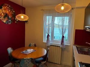 a kitchen with a table and a window at Apartament Lyonnet in Orşova