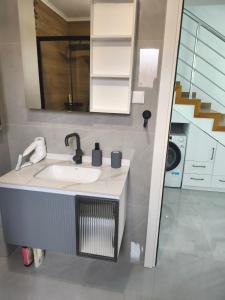 a bathroom with a sink and a mirror at Apartmani Orlović Bar in Bar +73 photos
