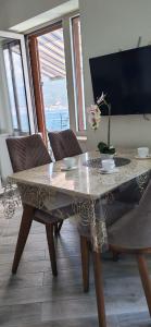 a table with a vase on it in a room at Marso in Krašići
