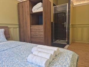 a bedroom with a bed with towels on it at Small Modern Rooms in Luxembourg +3 photos