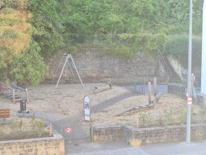 an empty playground with an old fashioned swing set at Small Modern Rooms in Luxembourg