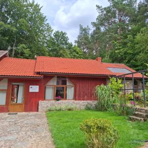 a red house with a red roof at Silnowo Kwietny Raj in Silnowo