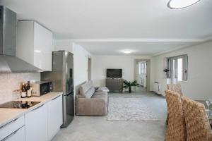 a kitchen and living room with a couch and a refrigerator at Marso in Krašići