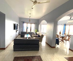 a living room with couches and a dining room at Dona Paula Apartment in Dona Paula