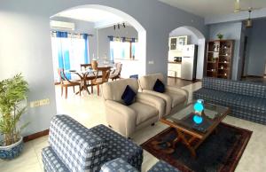 a living room with two couches and a table at Dona Paula Apartment in Dona Paula