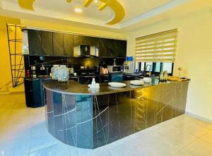 a large kitchen with a large island in the middle at Dahab Luxury Villa with Private Pool in Al Rama