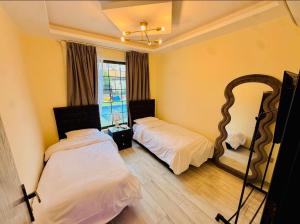 a bedroom with two beds and a large mirror at Dahab Luxury Villa with Private Pool in Al Rama
