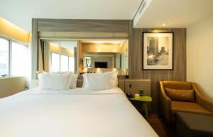 a hotel room with a large bed and a chair at Radisson V Olimpia in São Paulo +32 photos