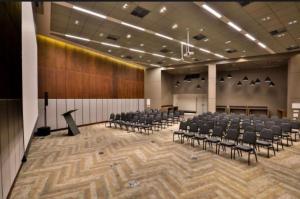 a large room with chairs and a stage in it at Radisson V Olimpia in São Paulo