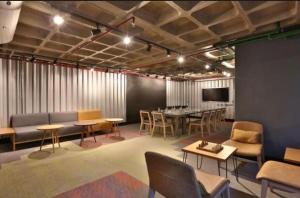 a meeting room with tables and chairs and a tv at Radisson V Olimpia in São Paulo
