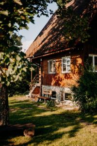 a wooden house with a bench in front of it at Chata u Karla in Rudná pod Pradědem