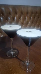 two martini glasses sitting on a table at The Crewe Arms Hotel in Crewe