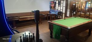 a room with a pool table and a video game at The Crewe Arms Hotel in Crewe